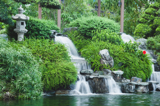 A close up view of cascading water falling over the rocks at Longshan Buddhist temple in Taipei city, Taiwan