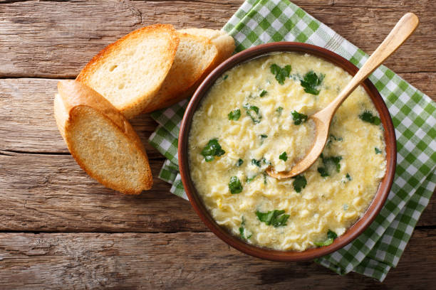 istock Italian egg soup stracciatella with farfalline pasta and parmesan close-up. horizontal top view 978356572