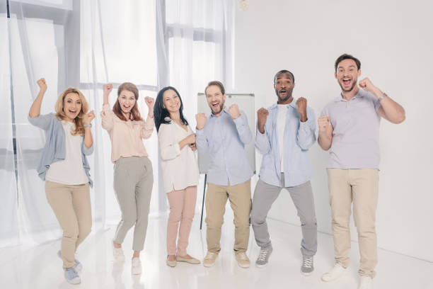istock cheerful multiethnic middle aged people triumphing and smiling at camera 978356604