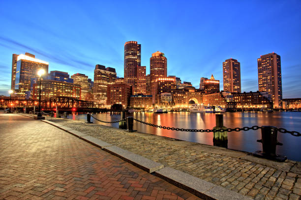 boston skyline with financial district and boston harbor at dusk - boston harbor imagens e fotografias de stock