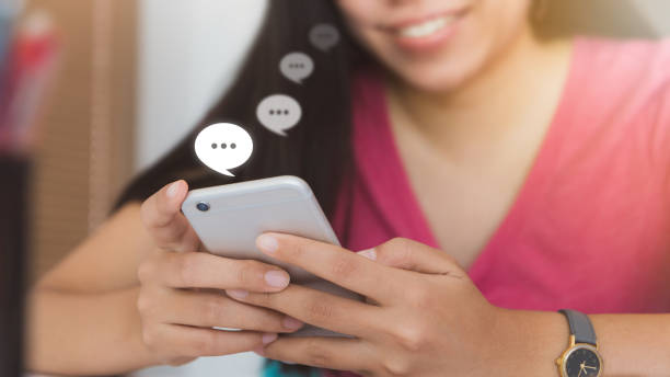 istock Woman using smartphone with Live Chat Chatting on white table in office space.Concept of business people use technology. 978357216