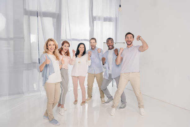 istock happy multiethnic mid adult people triumphing and smiling at camera 978357540