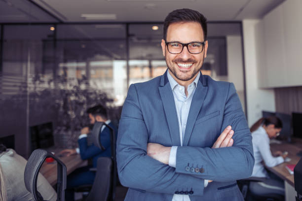 istock Happy confident businessman standing arms crossed 978363820