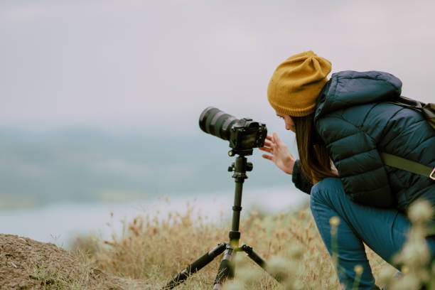 istock young woman shooting with camera at morning.Tripod and mirrorless camera 978364372