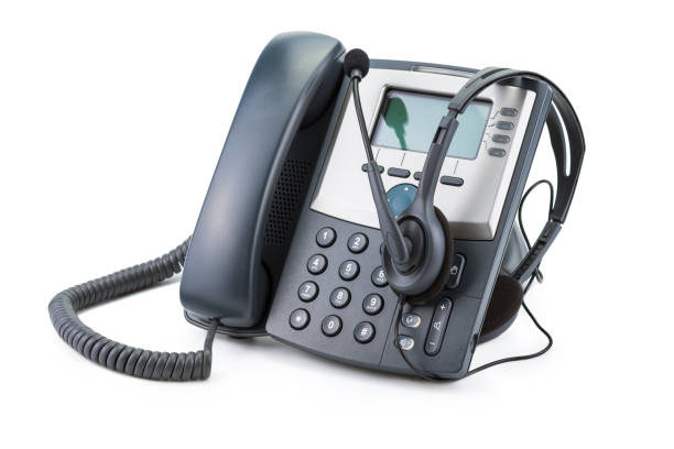 IP Telephone device with headset isolated on white background stock photo