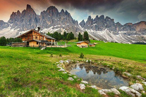 Spectacular alpine chalets with mountain lake in Dolomites, Italy, Europe