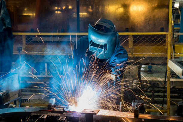 trabajador industrial es soldadura parte automotriz de montaje en fábrica del coche - construction built structure building activity shipyard fotografías e imágenes de stock