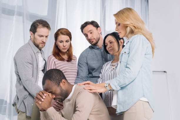 istock multiethnic group of people supporting upset african american man during therapy 978379576