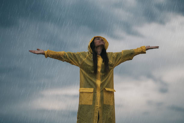 Young attractive girl is enjoying the summer rain