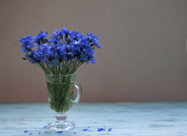 istock Small bouquet of cornflowers on a table of boards 978401606