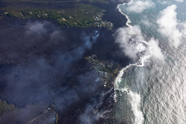 Aerial view of lava flows from the eruption of Kilauea volcano in Hawaii flowing into the sea near Kapoho, May 2018 Aerial view of lava flows from the eruption of Kilauea volcano in Hawaii flowing into the sea near Kapoho, May 2018 pele stock pictures, royalty-free photos & images