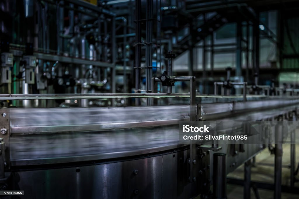 soda cans to pass with speed on the factory line. Alcohol - Drink Stock Photo