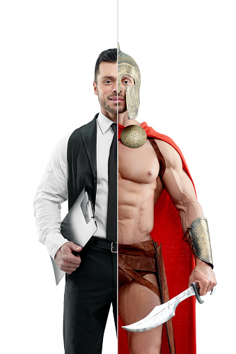 Comparison of manager and ancient warrior's outlook. Manager wearing classic white shirt with black tie and keeping black folder. Ancient Spartan warrior wearing red cape and holding a matallic sword.