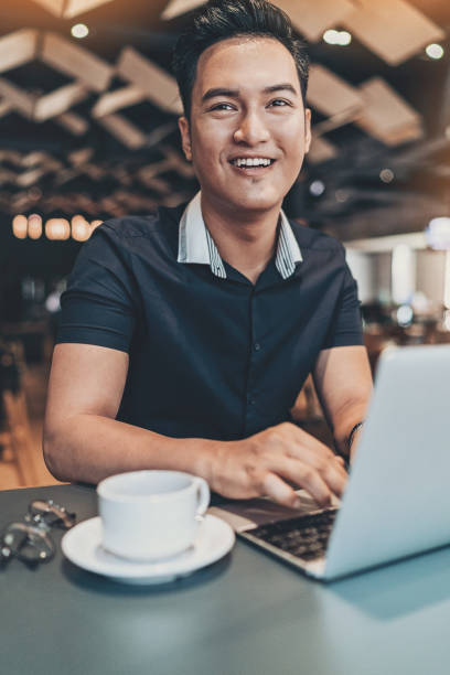 istock Young man with laptop in restaurant 978422666