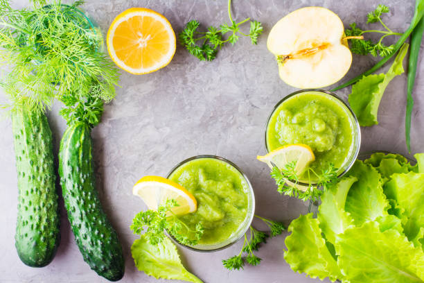 istock Refreshing smoothies from cucumber, green apple, fresh herbs and lemon juice in transparent glasses on the table 978426564
