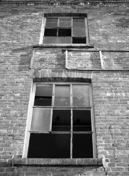 istock monochrome image of broken windows in an  old abandoned industrial brick building 978427456