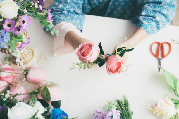 istock Female hands making beautiful flower composition in floral shop 978427524