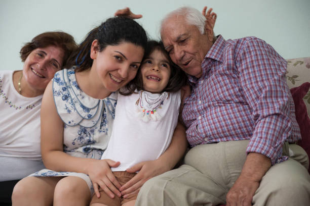 istock Multi generation Turkish family sitting on couch at home 978453568