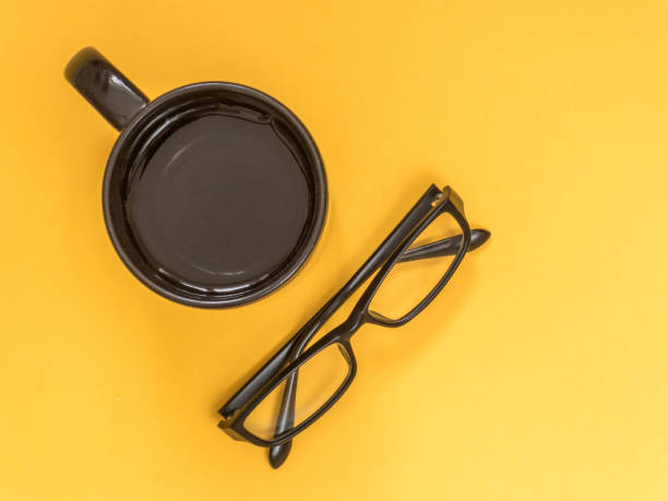 istock Flat lay black business accessories on yellow background with blank space for text. Top view. Copy space. 978469266