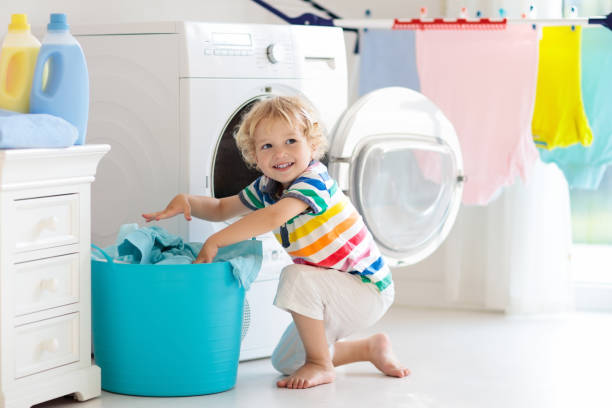 istock Child in laundry room with washing machine 978477076