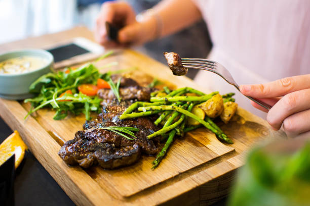 Female having a steak in the restaurant close up