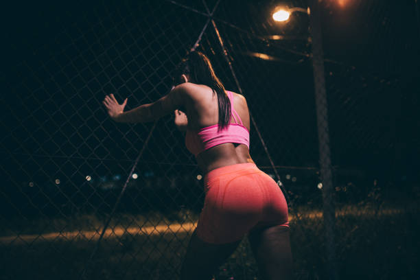 istock Sporty young woman at night 978491938