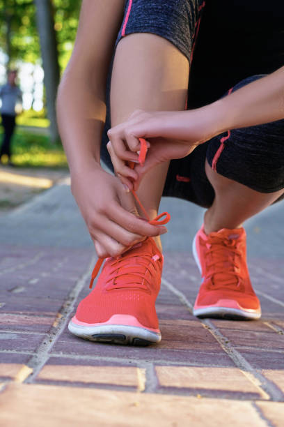 istock Closeup woman tying shoe laces. 978496604