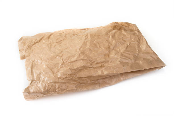 istock Used brown crumpled paper bag on the white. 978505806
