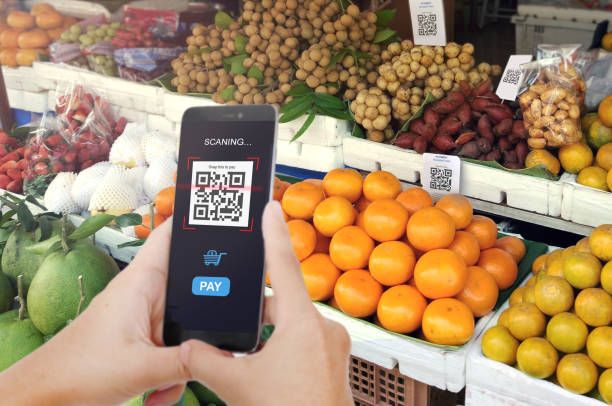 Qr code payment, E wallet , cashless technology concept. Man scanning tag Fresh Fruit in Market accepted generate digital pay without money.
