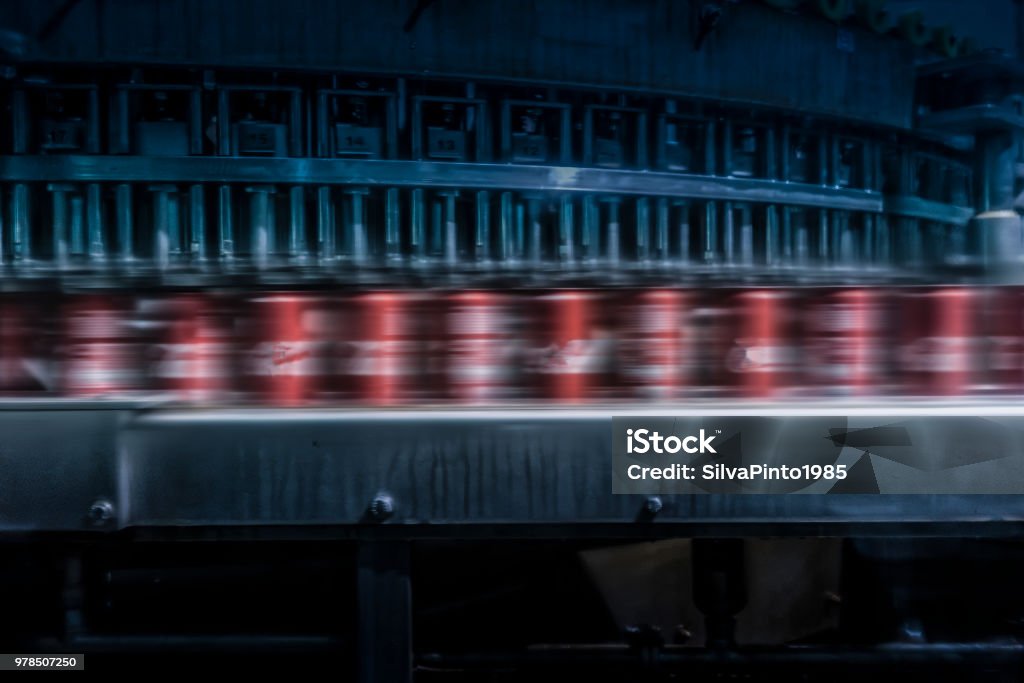 soda cans to pass with speed on the factory line. Carbonated Stock Photo