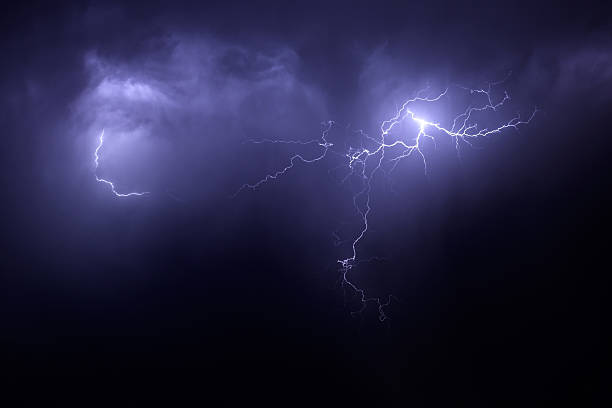 istock Nighttime lightening storm with streaks across purple sky 97850873