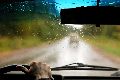 View of road traffic in rainy weather from inside an automobile. Concept of bad weather driving