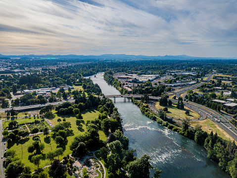Aerial view of Eugene Oregon with the Willamette River snaking its way through downtown Eugene. Iconic buildings including University Satdium and Knight Center in view.