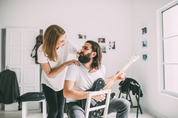istock Lovely couple playing guitar together 978513916