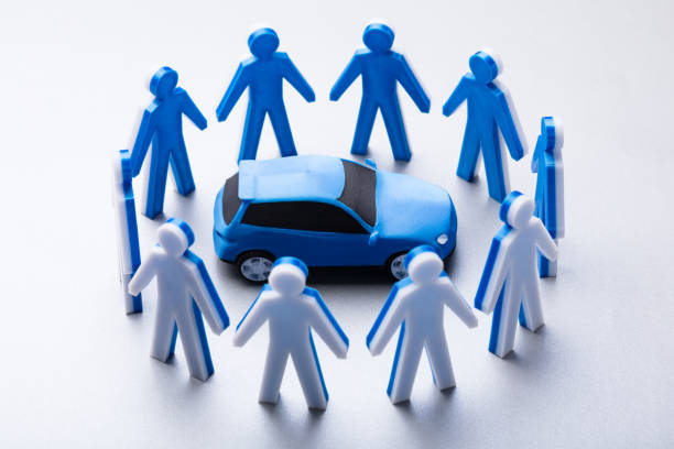 istock Elevated View Of Blue Car Surrounded By Human Figures 978520430