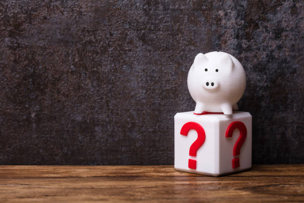 istock White Piggybank Over Cubic Block With Question Mark Sign 978520594
