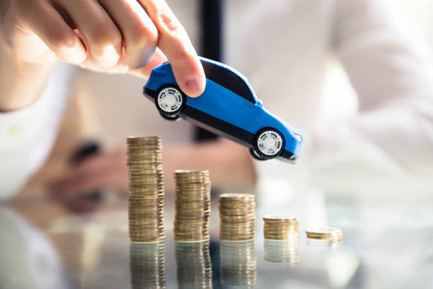 istock Person Flying Car Over Declining Stacked Coins 978523664