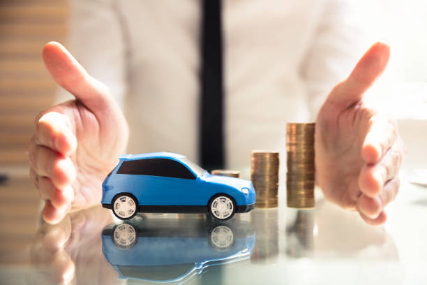 istock Person Protecting Increasing Stacked Coins And Car 978523758