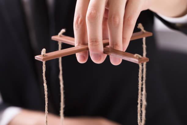 istock Businessperson Manipulating Marionette 978525530