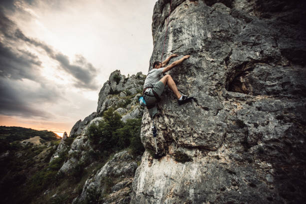 istock Disability brave man with prosthetic leg climbing up a mountain 978526558