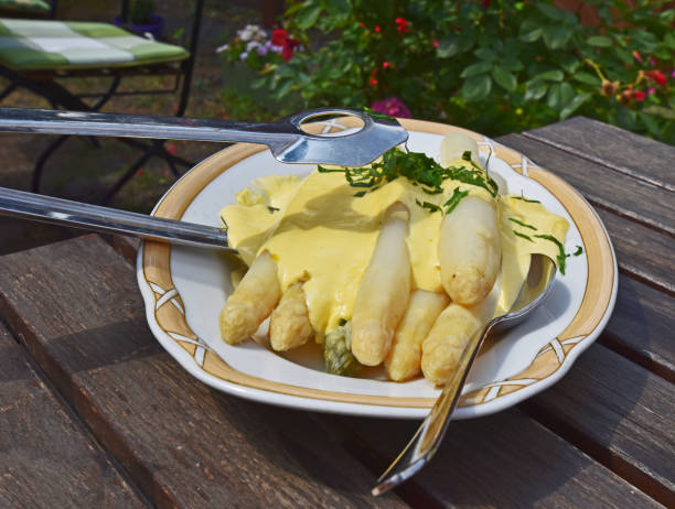 Fresh white asparagus from Beelitz (Germany) on a plate with sauce hollandaise and asparagus tongs Fresh white asparagus from Beelitz (Germany) on a plate with sauce hollandaise and asparagus tongs beelitz stock pictures, royalty-free photos & images
