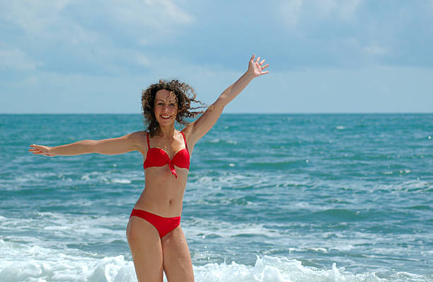 istock Happy woman stand at coast 97852766