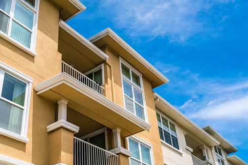 Real Estate Development , Rent , and Housing in Santa Cruz , California , USA blue sky and orange modern condo style building near downtown Santa Cruz