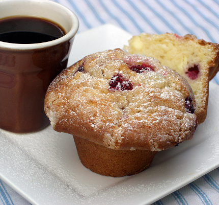 Tasty baked berry muffins partner up perfectly with a freshly brewed coffee.