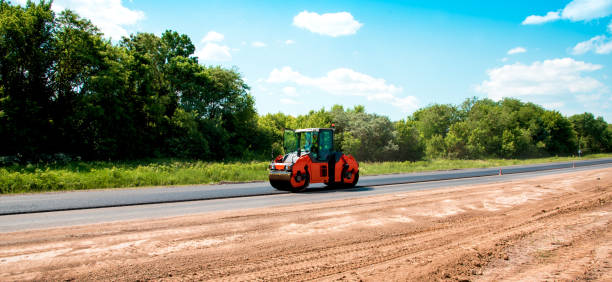 istock industrial landscape with rollers that rolls a new asphalt on the road. Repair work, complicated transport movement. 978535342