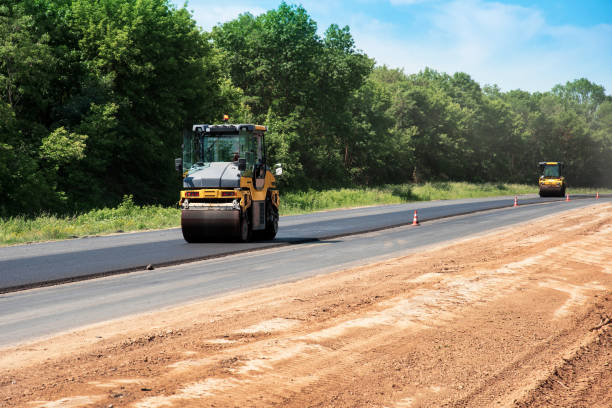 istock industrial landscape with rollers that rolls a new asphalt on the road. Repair work, complicated transport movement. 978535424