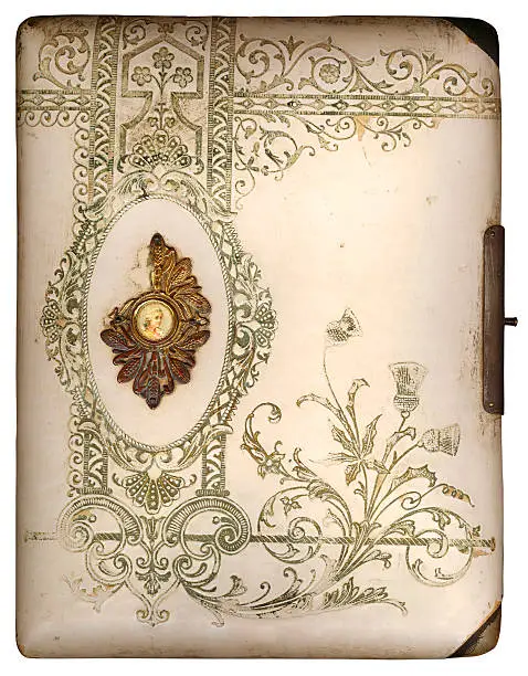 A hi res scan of a beautiful old floral patterned photo album. Complete with paintined cameo and grungy wear and tear.  Isolated on white.