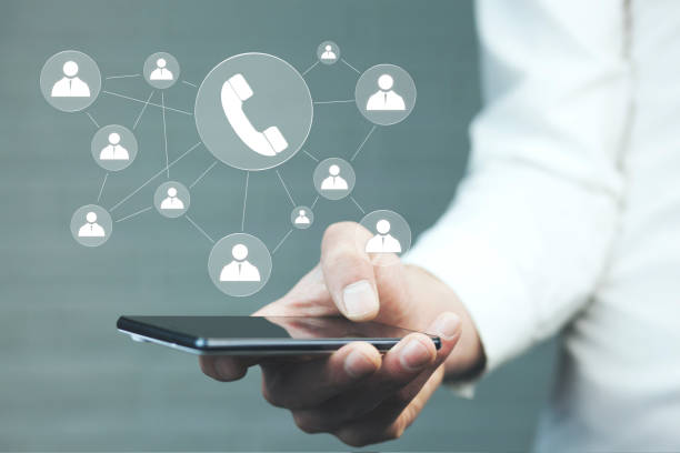 istock Hand holding smartphone with glowing mobile app icons 978545098
