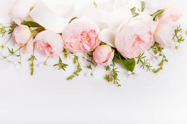 istock Festive flower composition on the white wooden background. Overhead view 978545468