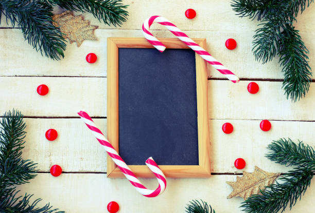 istock christmas, new year background, candy, spruce branches, golden leaves, blackboard 978552366